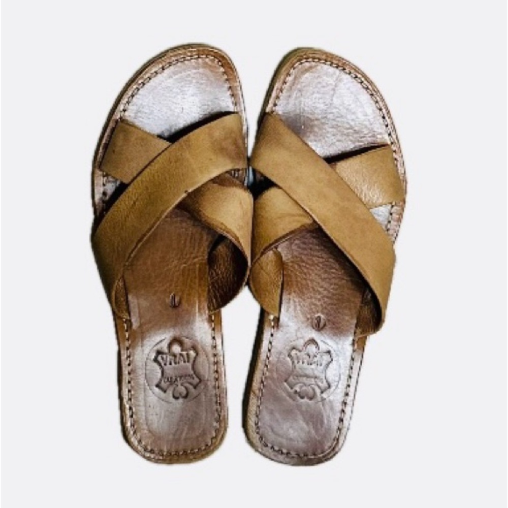 100% leather slip-on crossover sandal. Tan leather insole and straps.